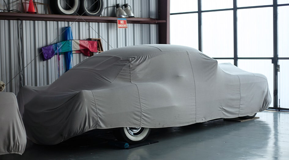 A car covered in a grey cover

Description automatically generated with low confidence