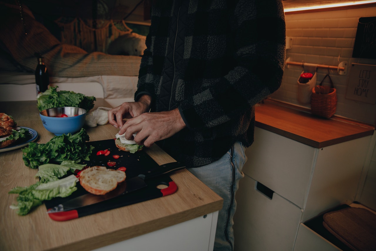 A person preparing food in a kitchen

Description automatically generated with medium confidence