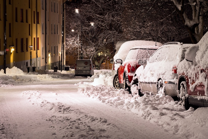 Cars completely covered in snow