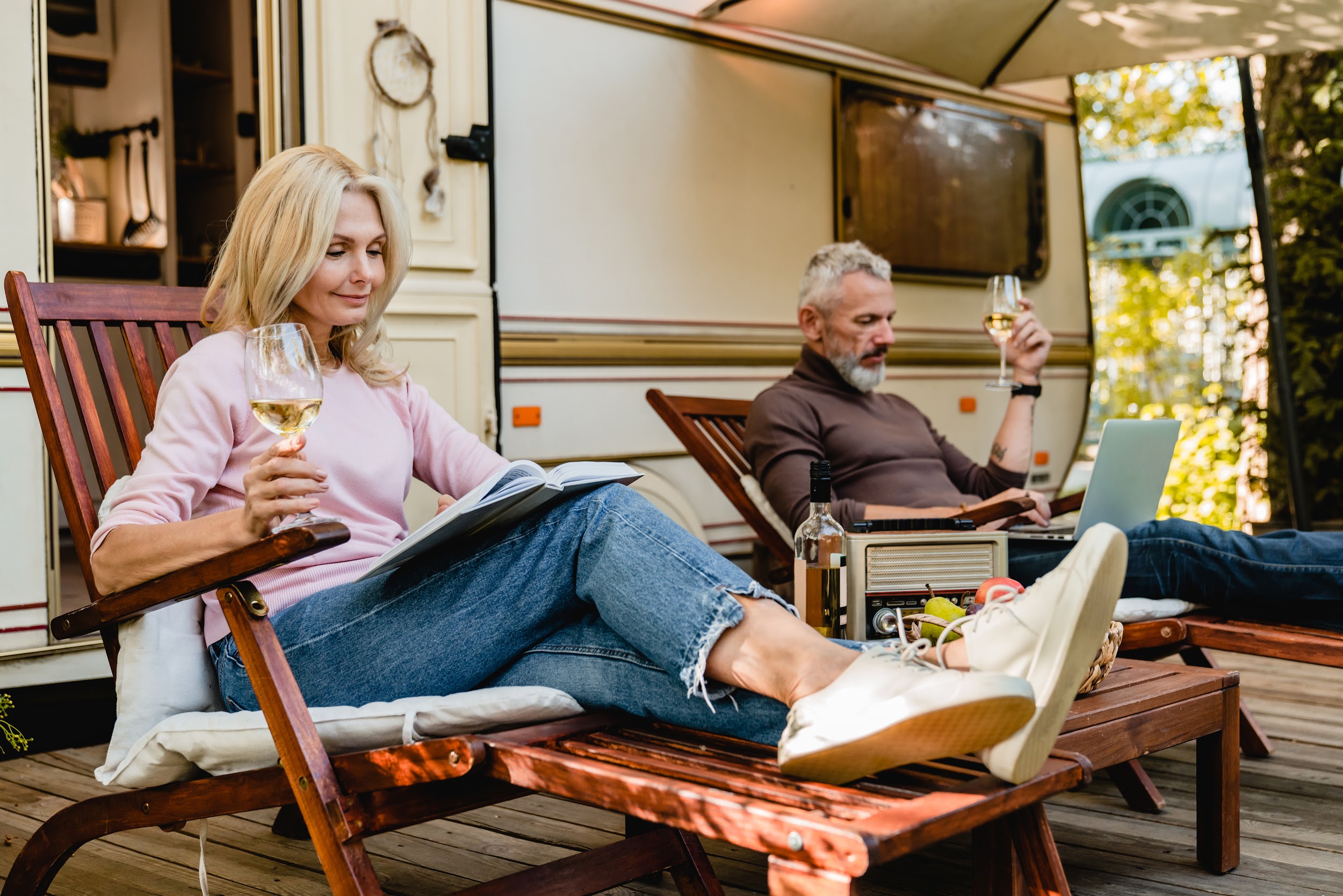 A couple sitting relaxing outside their RV