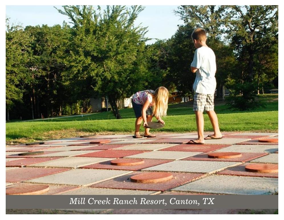 Two kids playing a giant checkers game at Mill Creek Ranch Resort in Canton Texas.