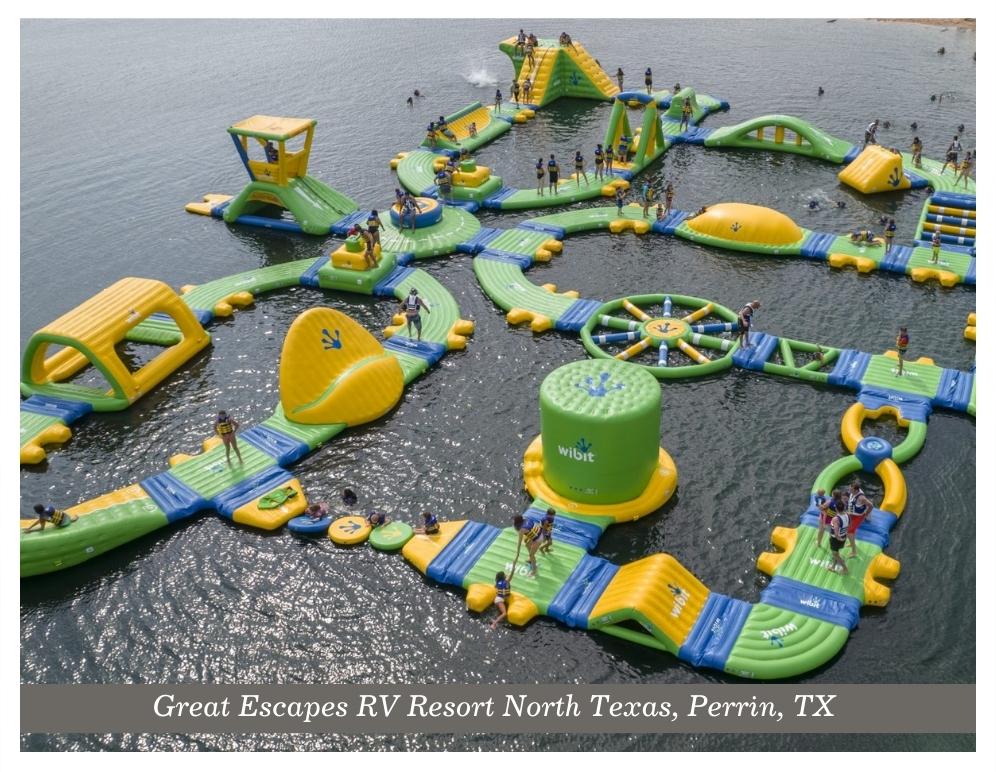 Kids playing on a floating water obstacle course at the Great Escapes RV Resort Nort Texas in Perrin Texas.