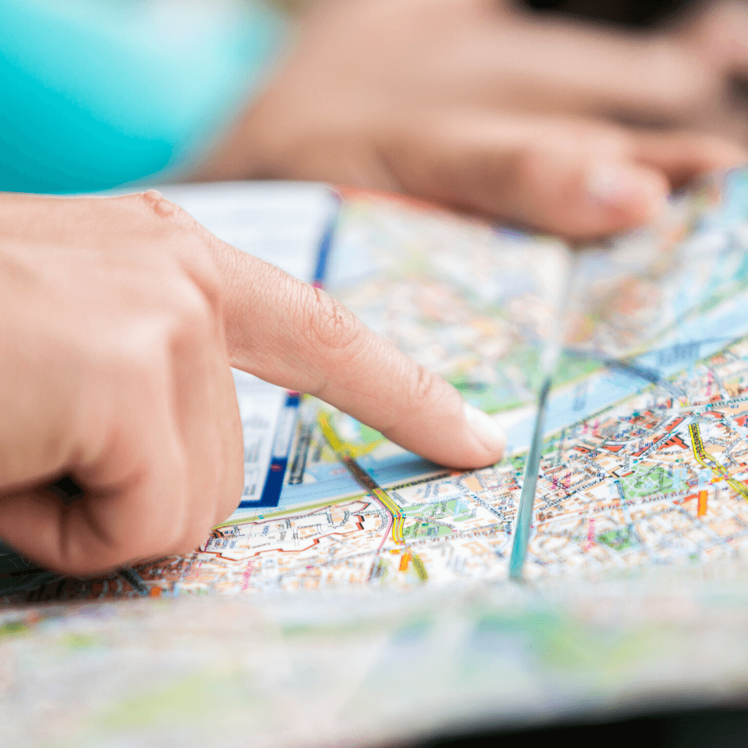 person pointing at a map for a location