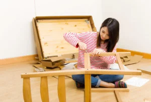 woman taking apart her furniture